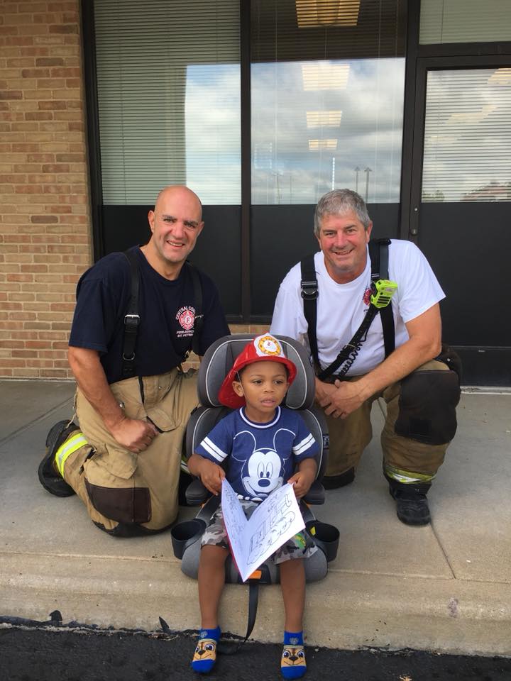 Members of CCFR's Community Outreach program with young citizen.