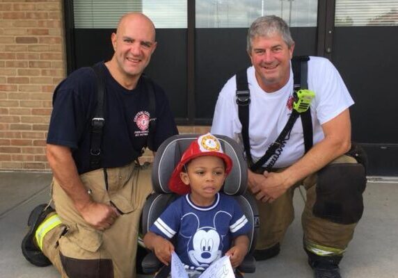 Members of CCFR's Community Outreach program with young citizen.