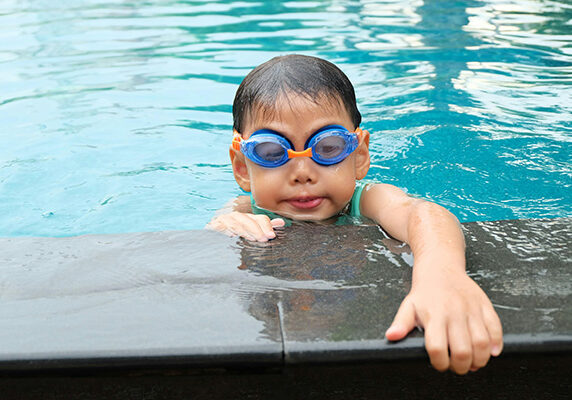 Young boy at the swimming pool